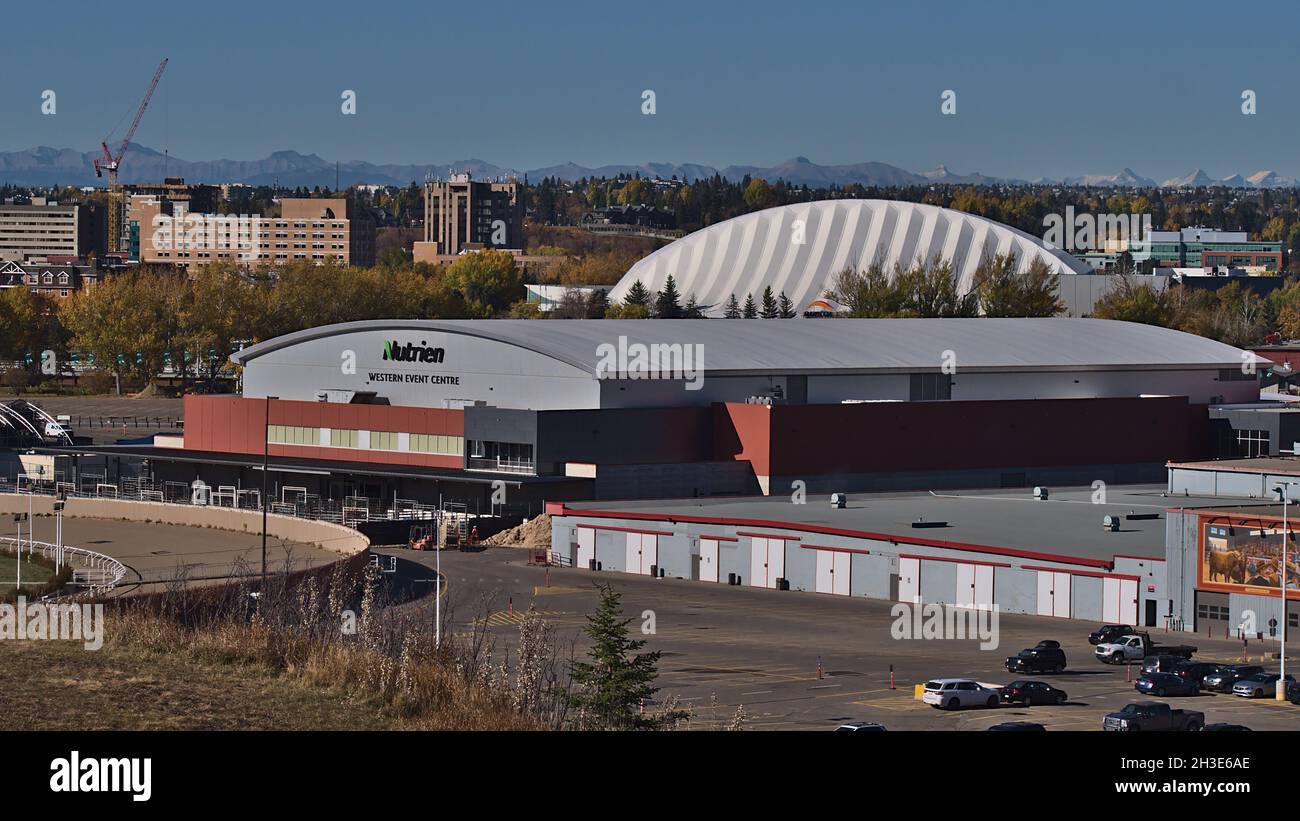 View of the Nutrien Western Event Centre in Calgary, part of the annual Stampede, on sunny day in autumn with Rocky Mountains in background. Stock Photo