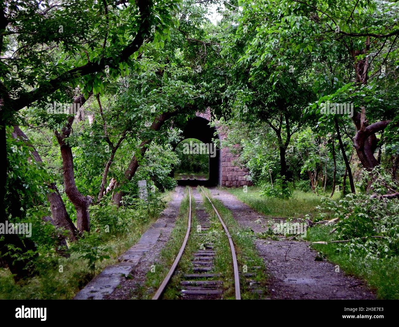 Abandoned narrow gauge railroad passing through the brick tunnel in Yerevan, Armenia Stock Photo