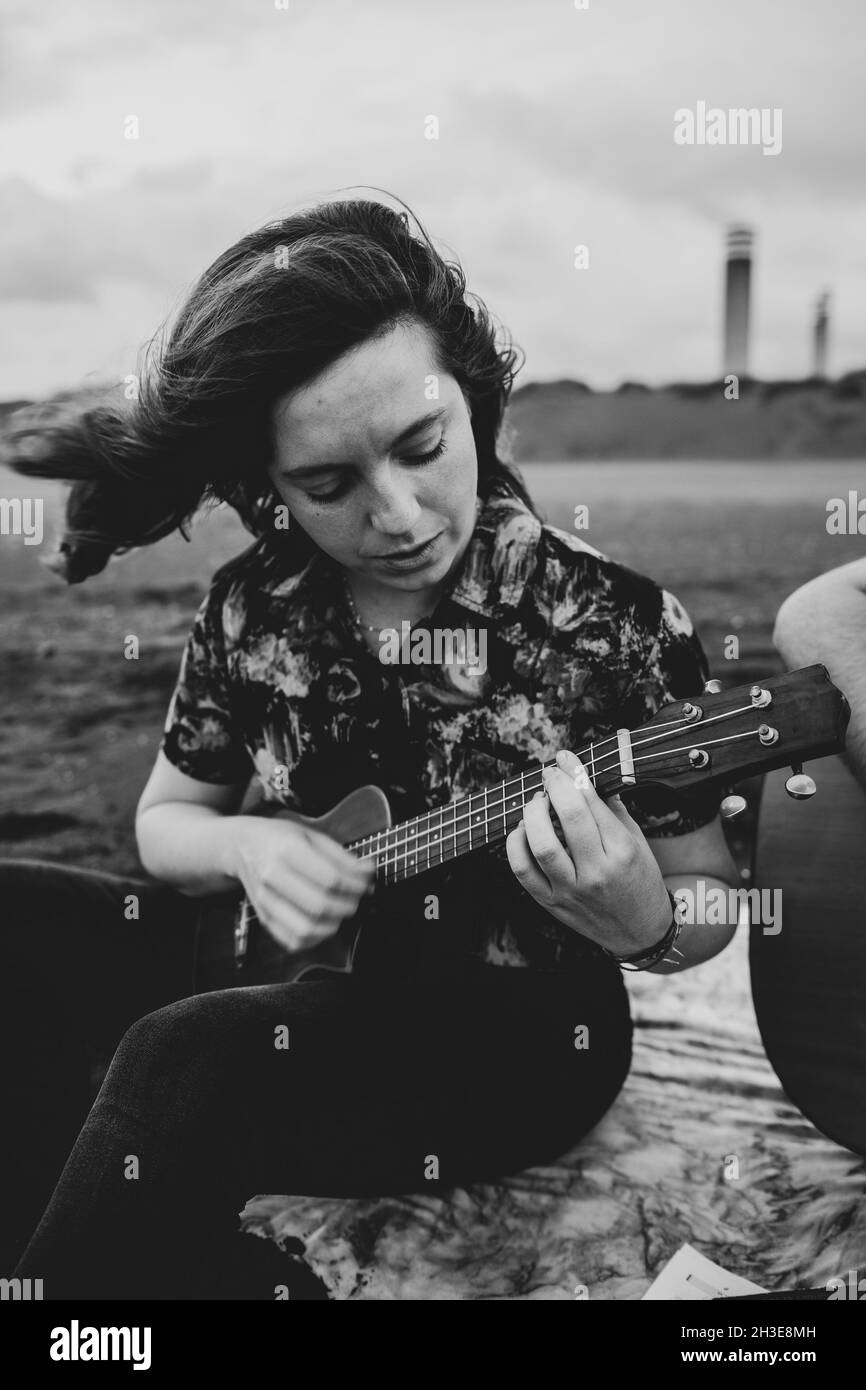 Play ukulele Black and White Stock Photos & Images - Alamy