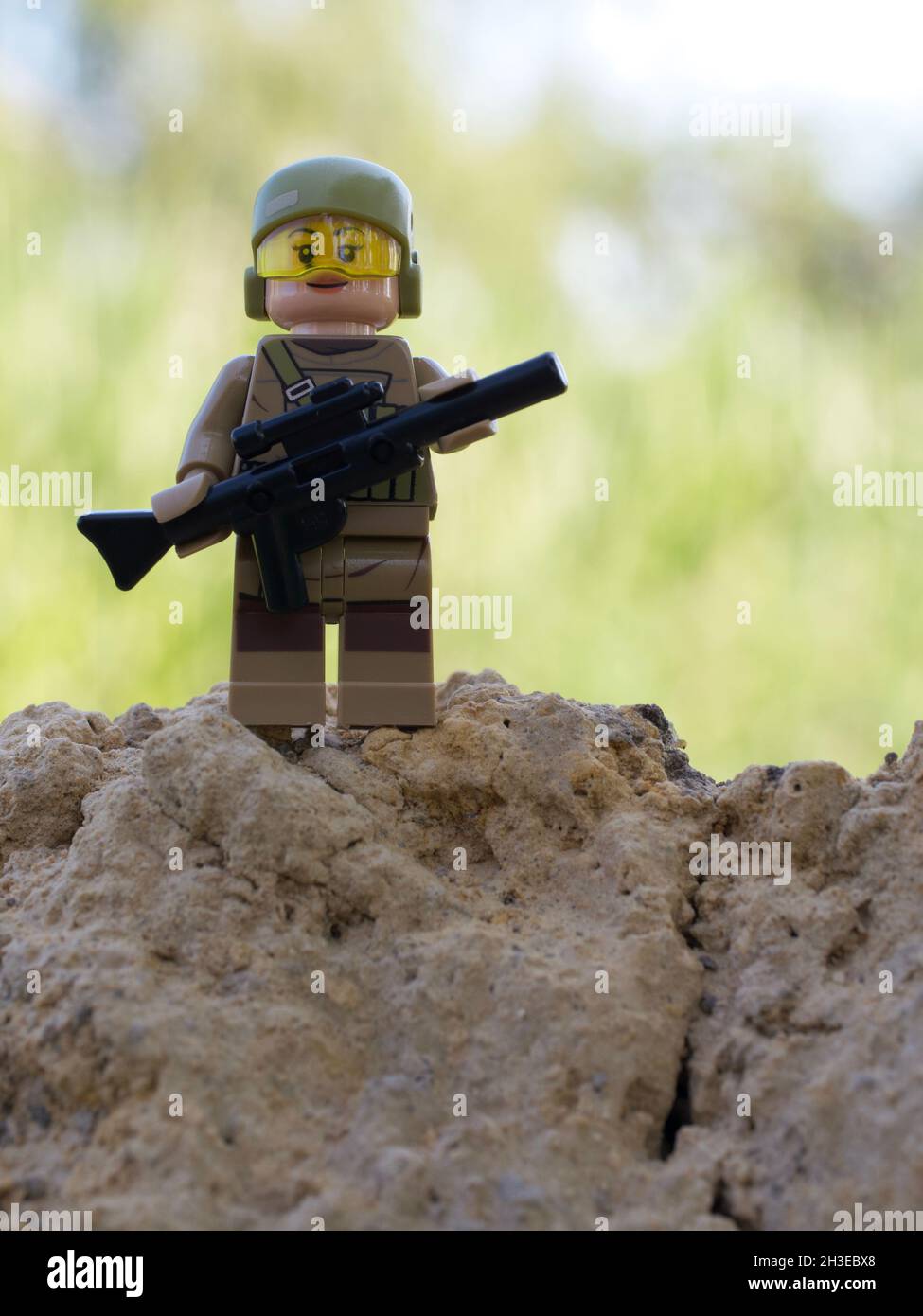 Chernihiv, Ukraine, July 13, 2021. A girl soldier armed with a rifle. A small plastic toy. Illustrative editorial. Stock Photo