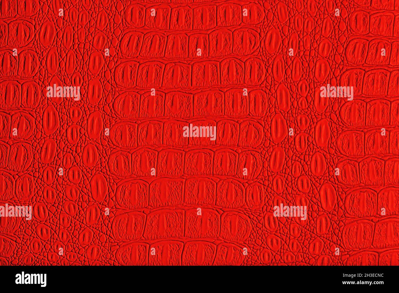 Red crocodile leather texture. Abstract background for design. Stock Photo
