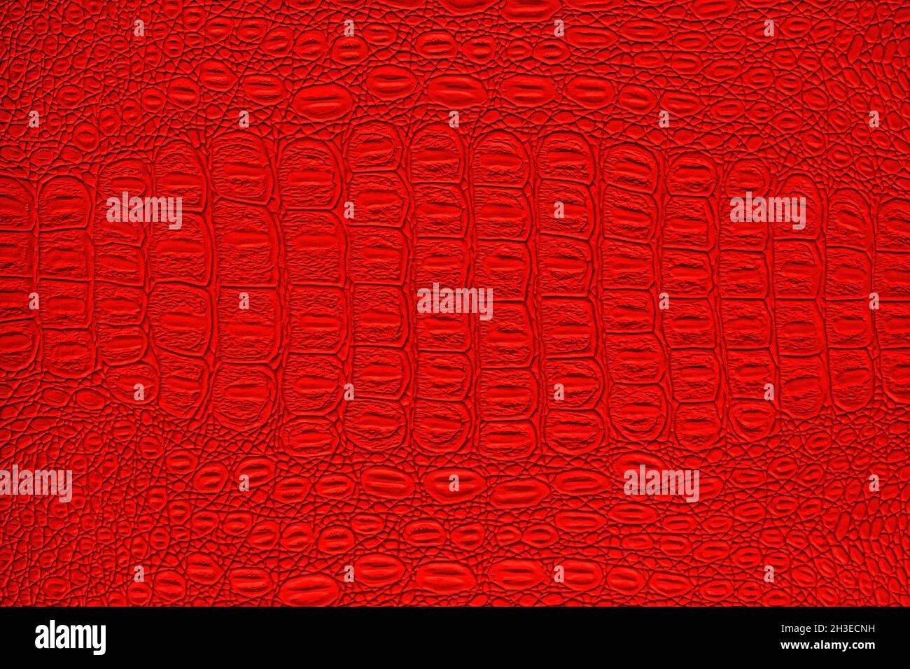 Red crocodile leather texture. Abstract background for design. Stock Photo