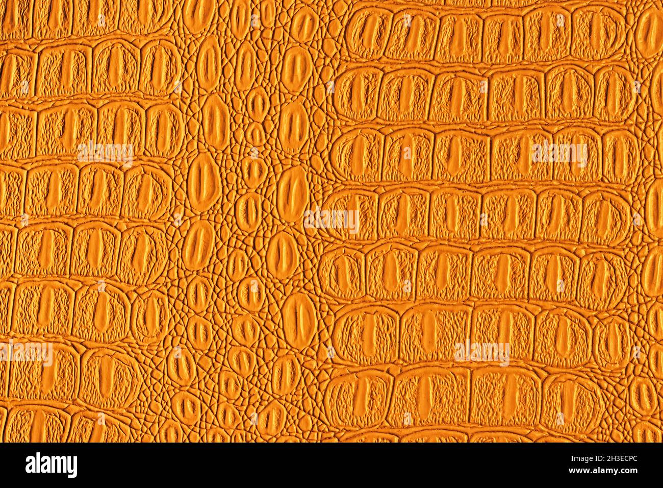 Orange crocodile leather texture. Abstract background for design. Stock Photo