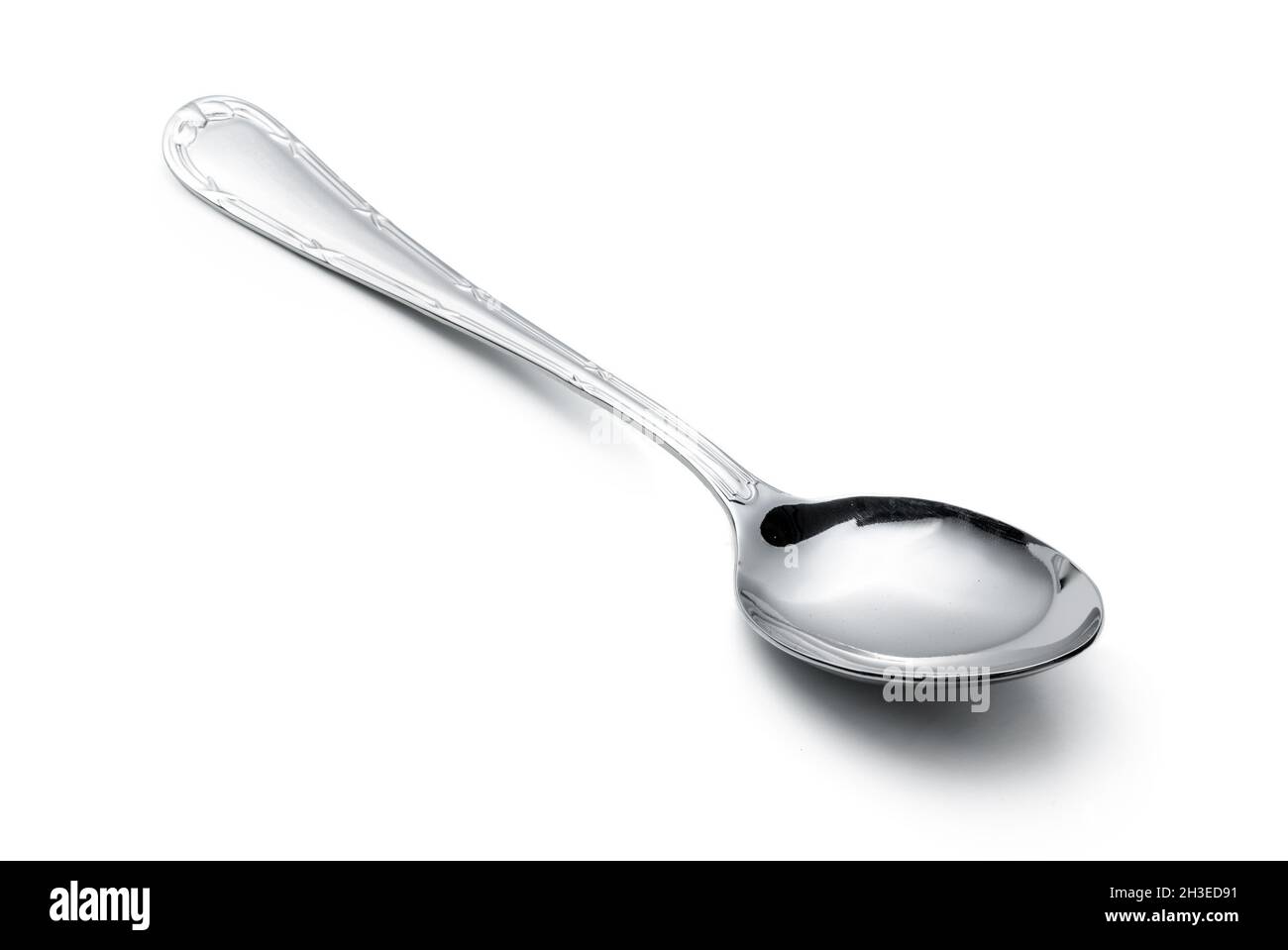 Silver shiny spoon isolated on white background Stock Photo - Alamy