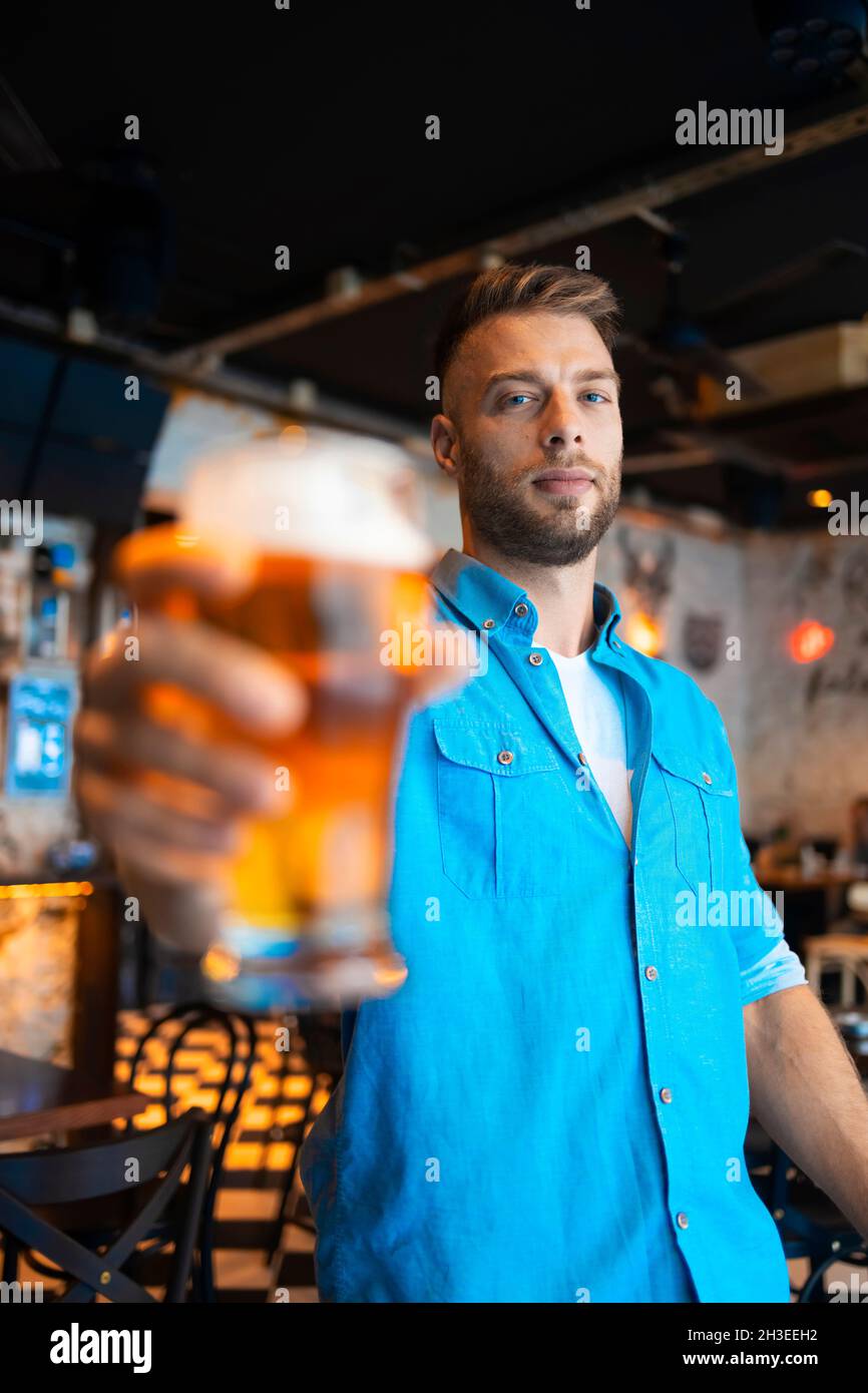A man with a glass of beer in a bar Stock Photo
