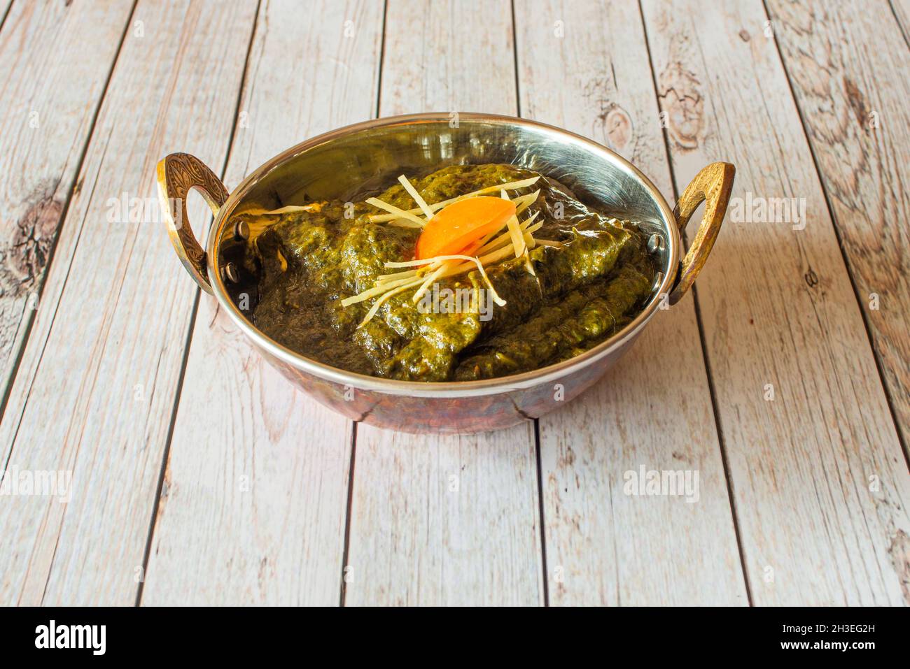 Palak paneer is an Indian cuisine dish consisting of spinach and Paneer cheese in a curry sauce. Palak paneer is a type of Saag, which can also be mad Stock Photo