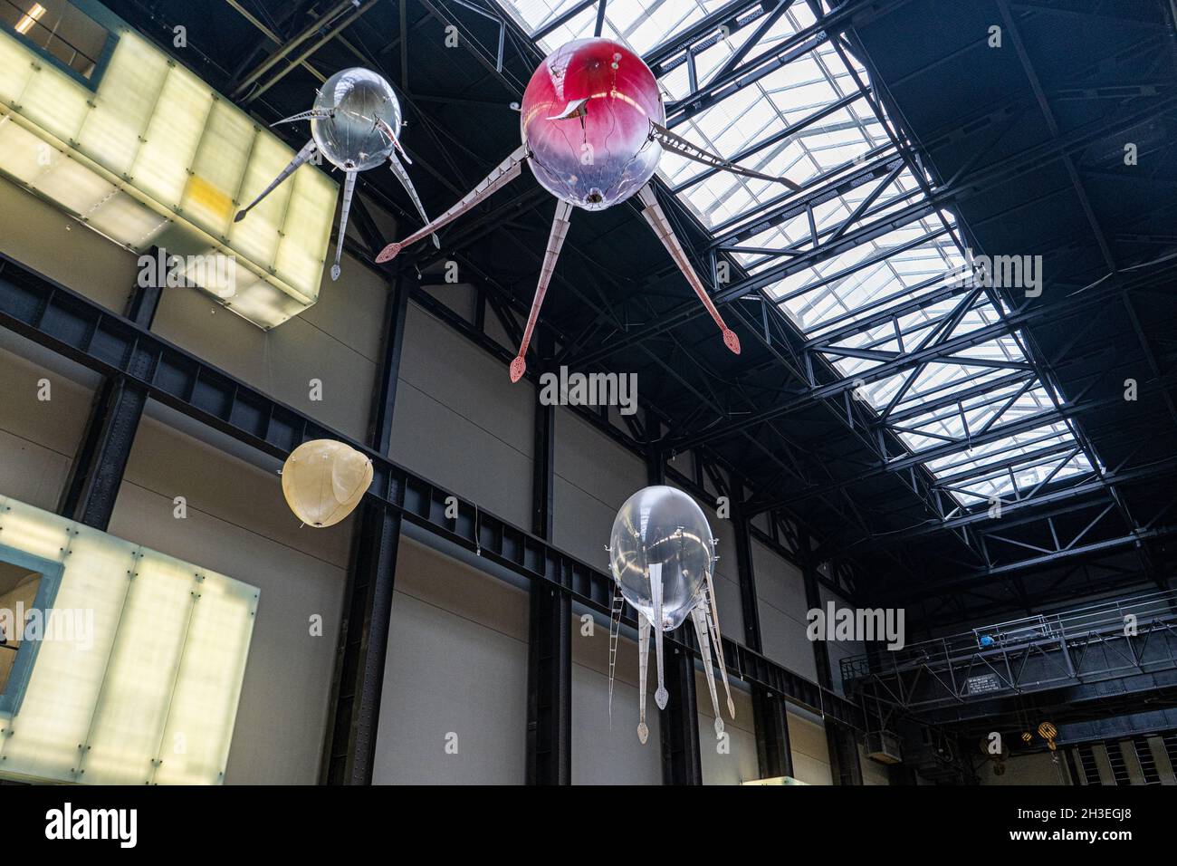 TATE MODERN LONDON, UK. 28 Oct, 2021. Anicka Yi 'In Love With the World' is an exhibition  within the Tate Modern Turbine hall with floating machines called aerobes  with the shape of uncrewed aerial vehicles (UAVs)  based on ocean life forms and mushrooms which follow a unique flight path generated from a vast range of options in their software. The aerobes’ individual and group behaviours develop over time, influenced by the ecosystem, including the heat signatures of people nearby. The exhibition runs from 15 October until 16 January 2022. amer ghazzal/Alamy Live News Stock Photo