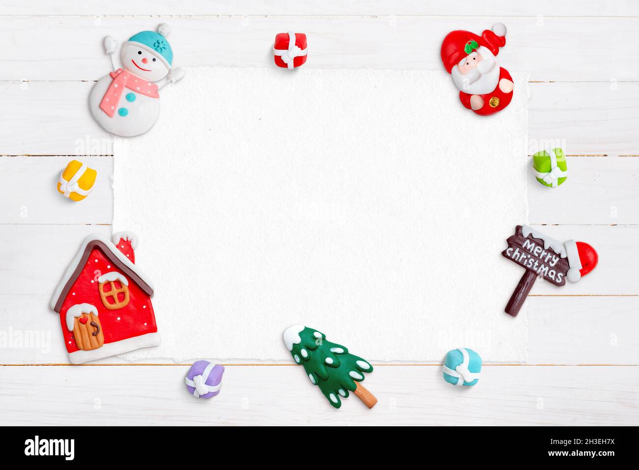 Blank paper od white wooden desk for greeting text, surrounded by Christmas decorations Stock Photo