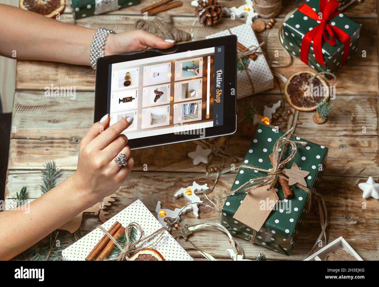 Female hands with tablet on table with hand made christmas decor Stock Photo