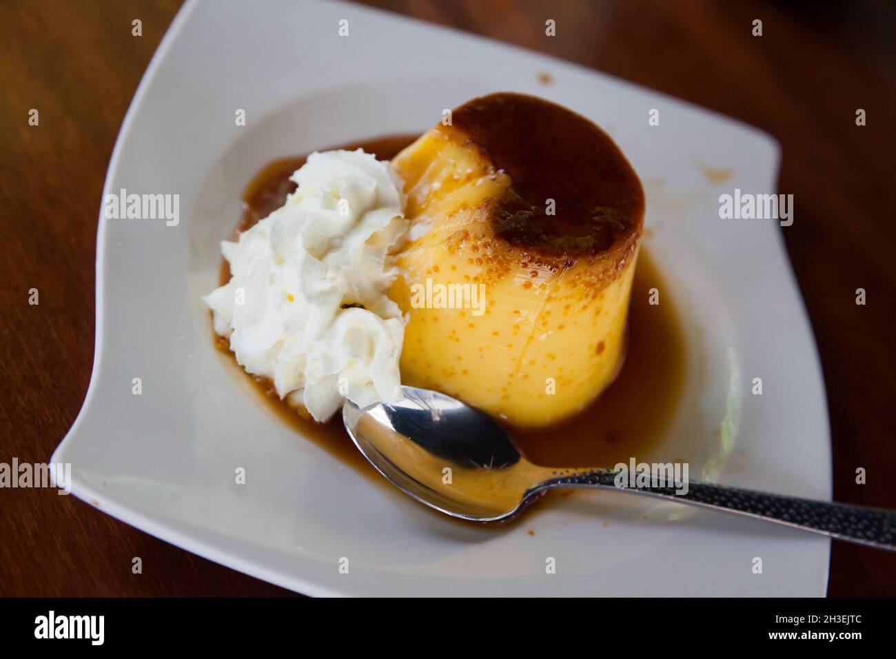 Spanish dessert flan with whipped cream Stock Photo Alamy
