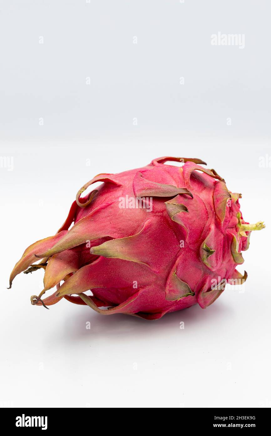Dragon fruit, pitaya on white background with shadow. A pitaya or pitahaya is the fruit of several cactus species indigenous to the Americas. Close up Stock Photo
