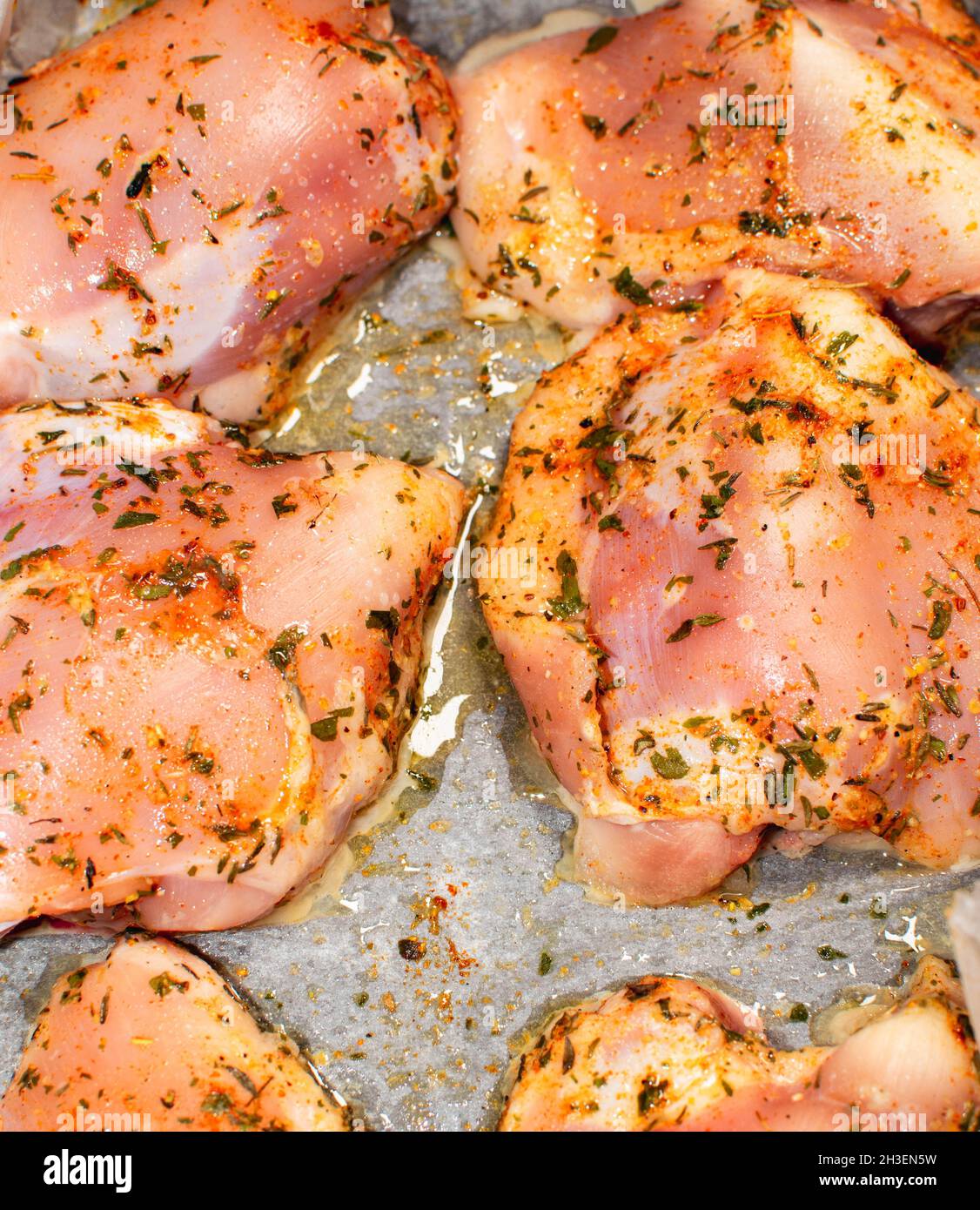 Parts of chicken with spices, a dish for a chicken family Stock Photo