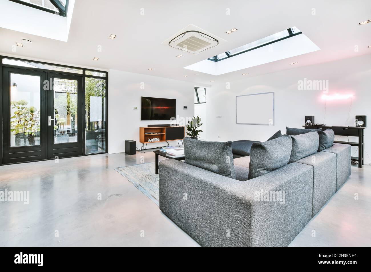 Elegant living room with a large TV and sofa Stock Photo - Alamy