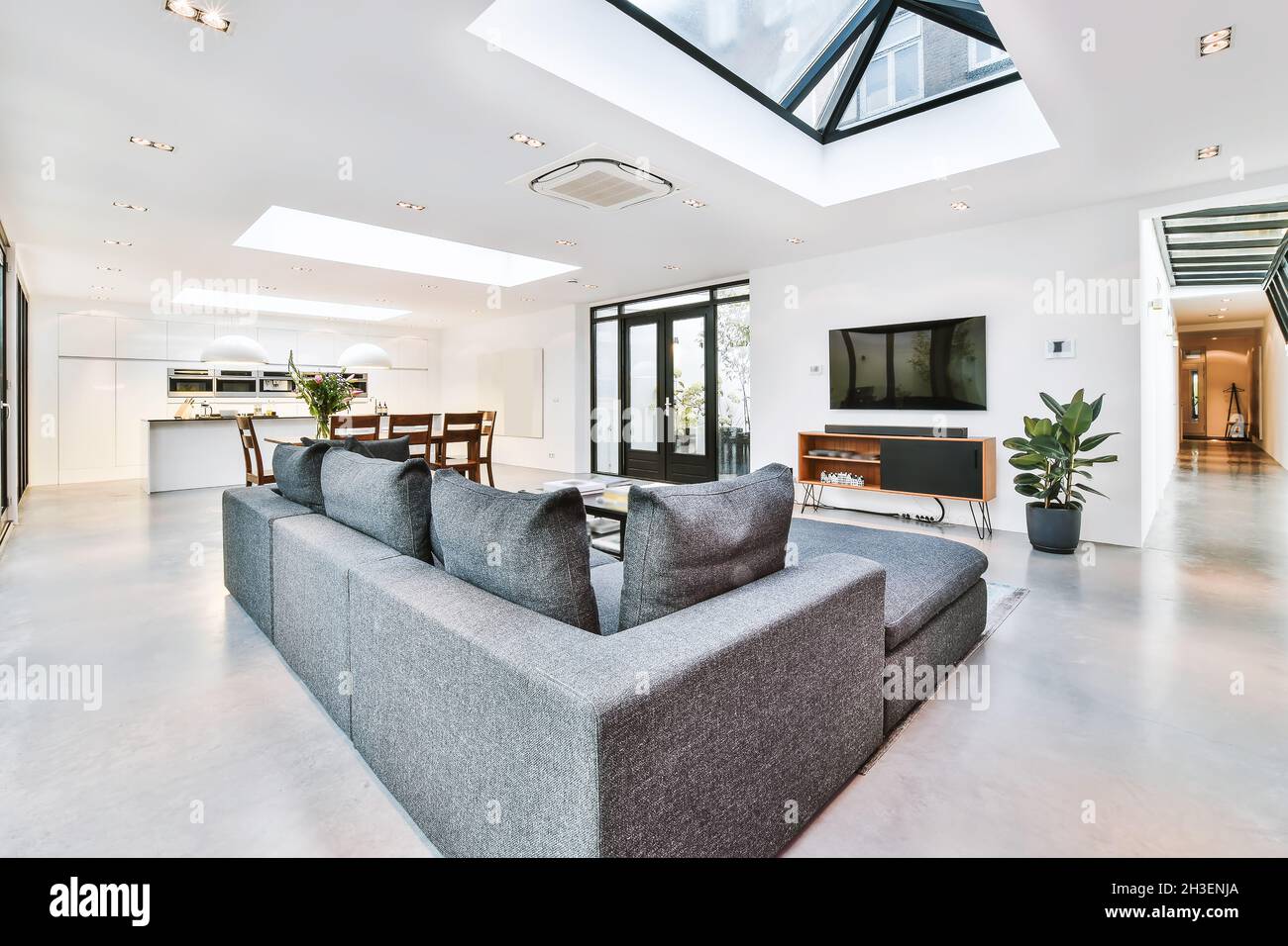 Elegant living room with a large TV and sofa Stock Photo - Alamy