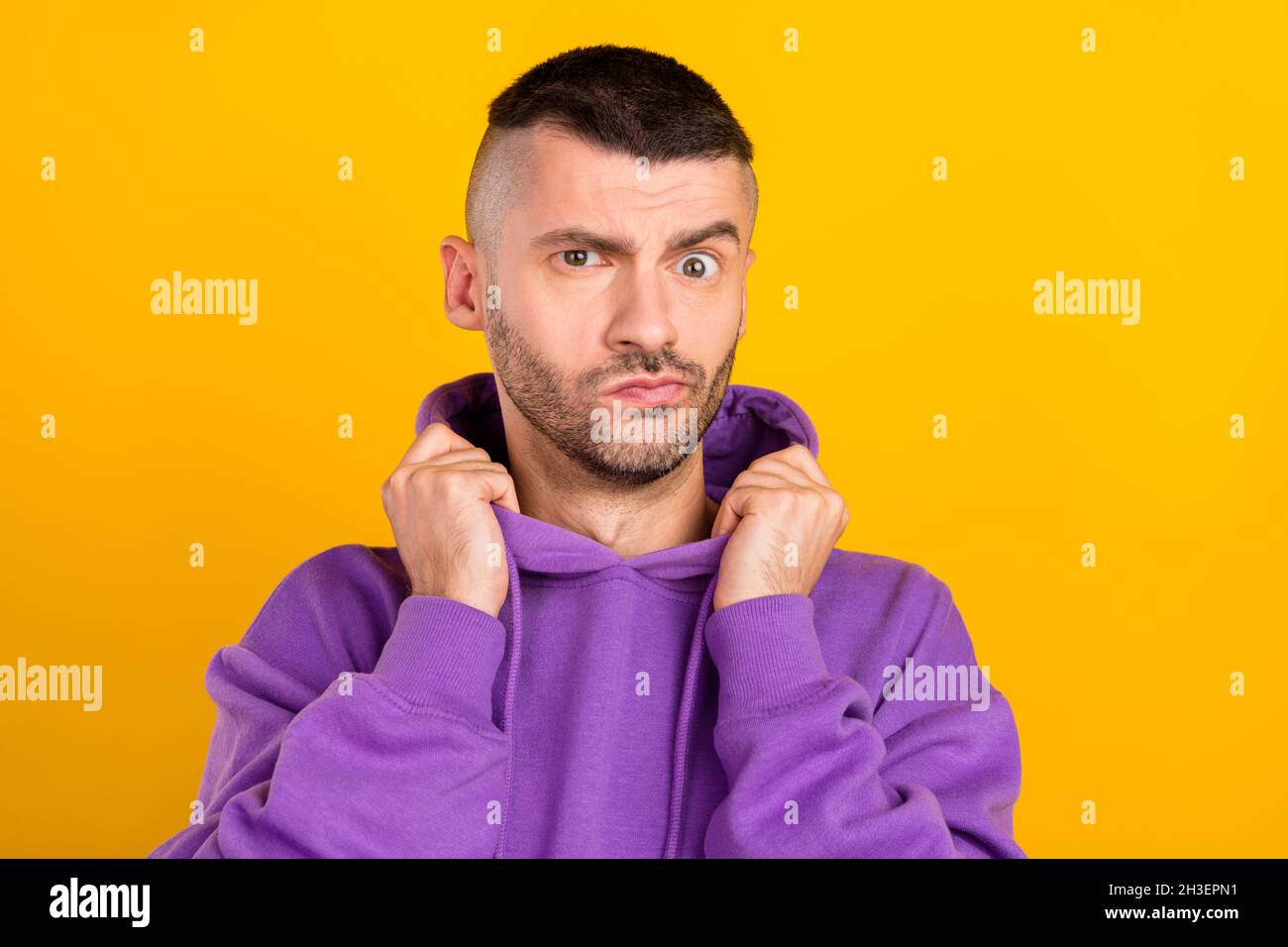 Photo portrait young man wearing purple hoody unsure got doubt isolated vibrant yellow color background Stock Photo