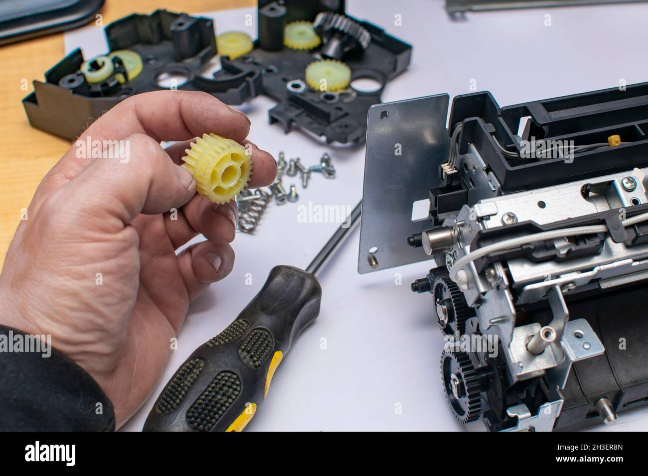 a plastic gear with grease in the hand of a man, a service center master Stock Photo Alamy