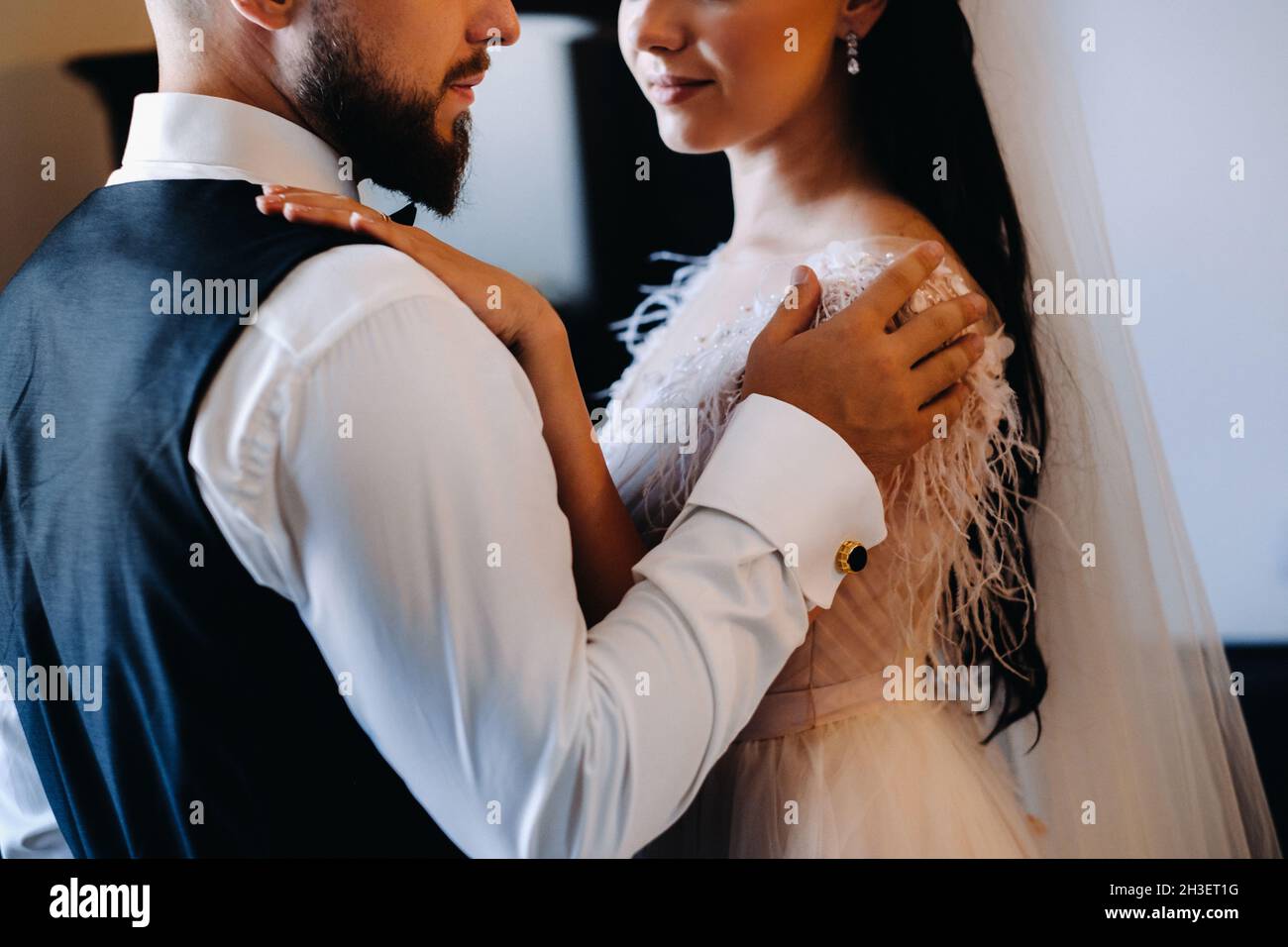 Morning of the bride. The groom stands with the bride near the mirror. Stock Photo