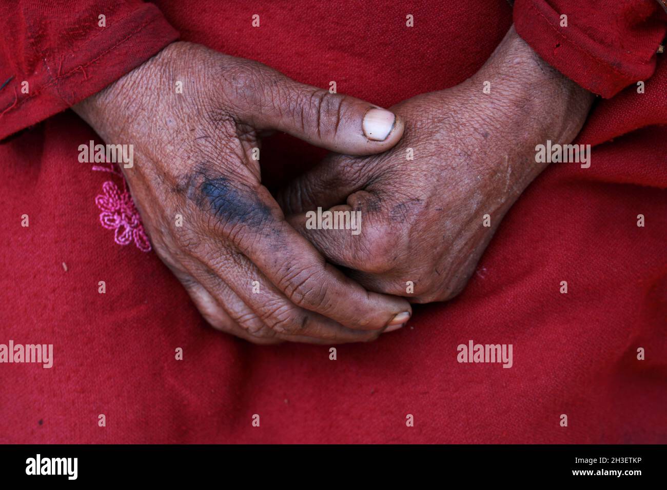 hand of old asian hardworking women on red clothes. Stock Photo