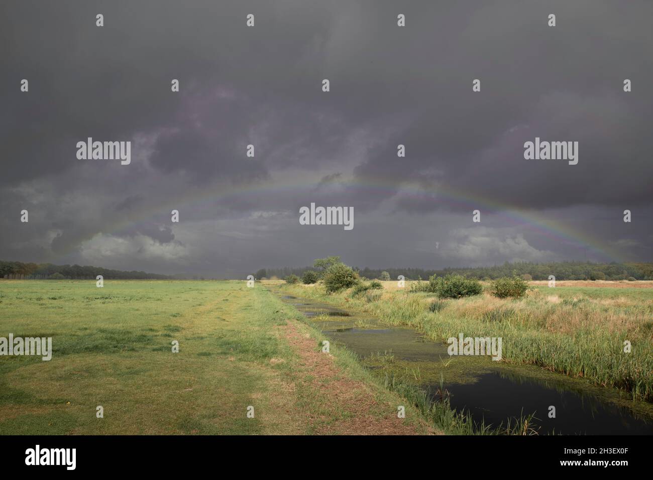 a rainbow and dark sky in holland Stock Photo