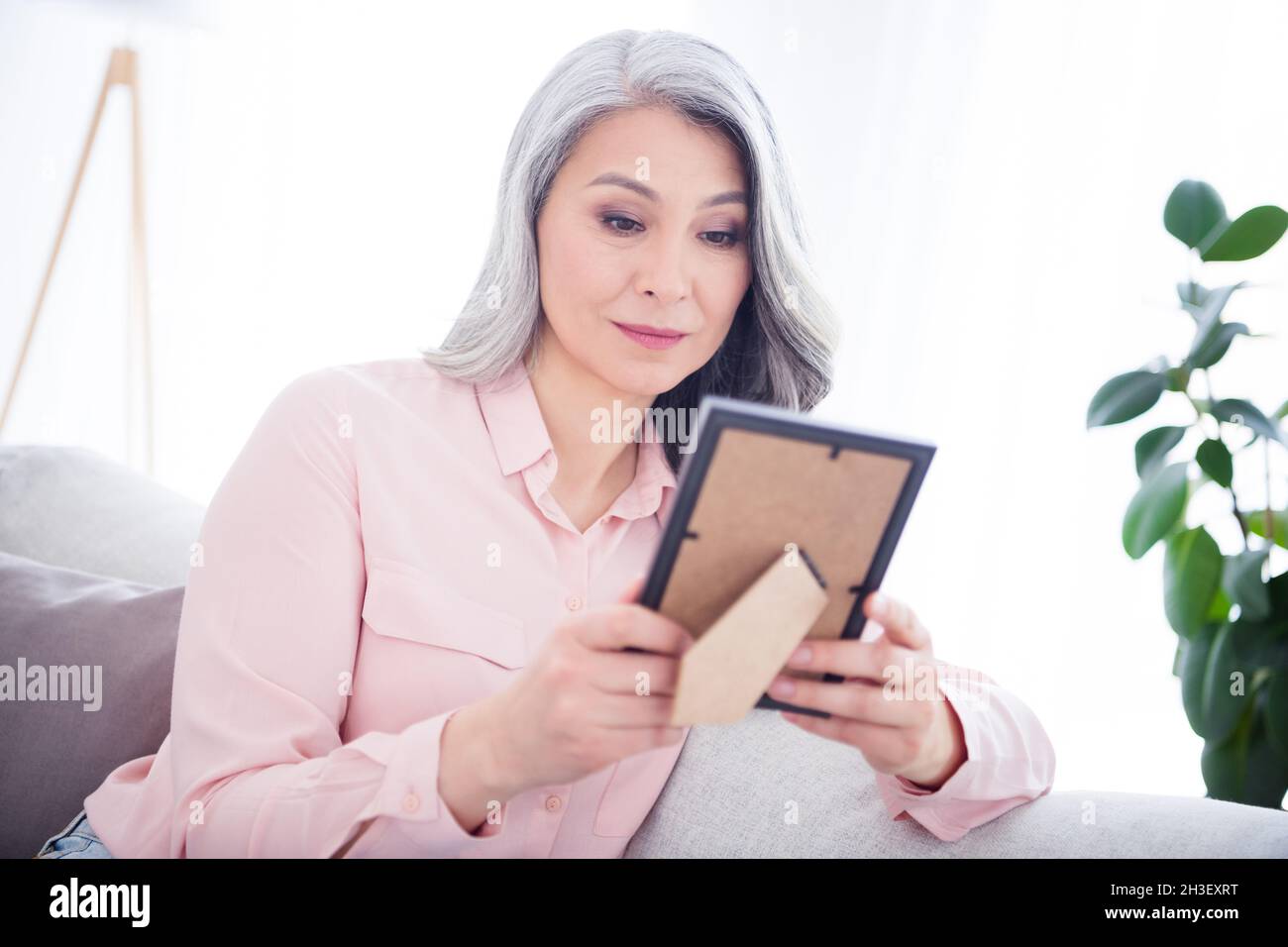 Remember Sitting Photo of attractive aged korean woman happy smile look photo frame ...