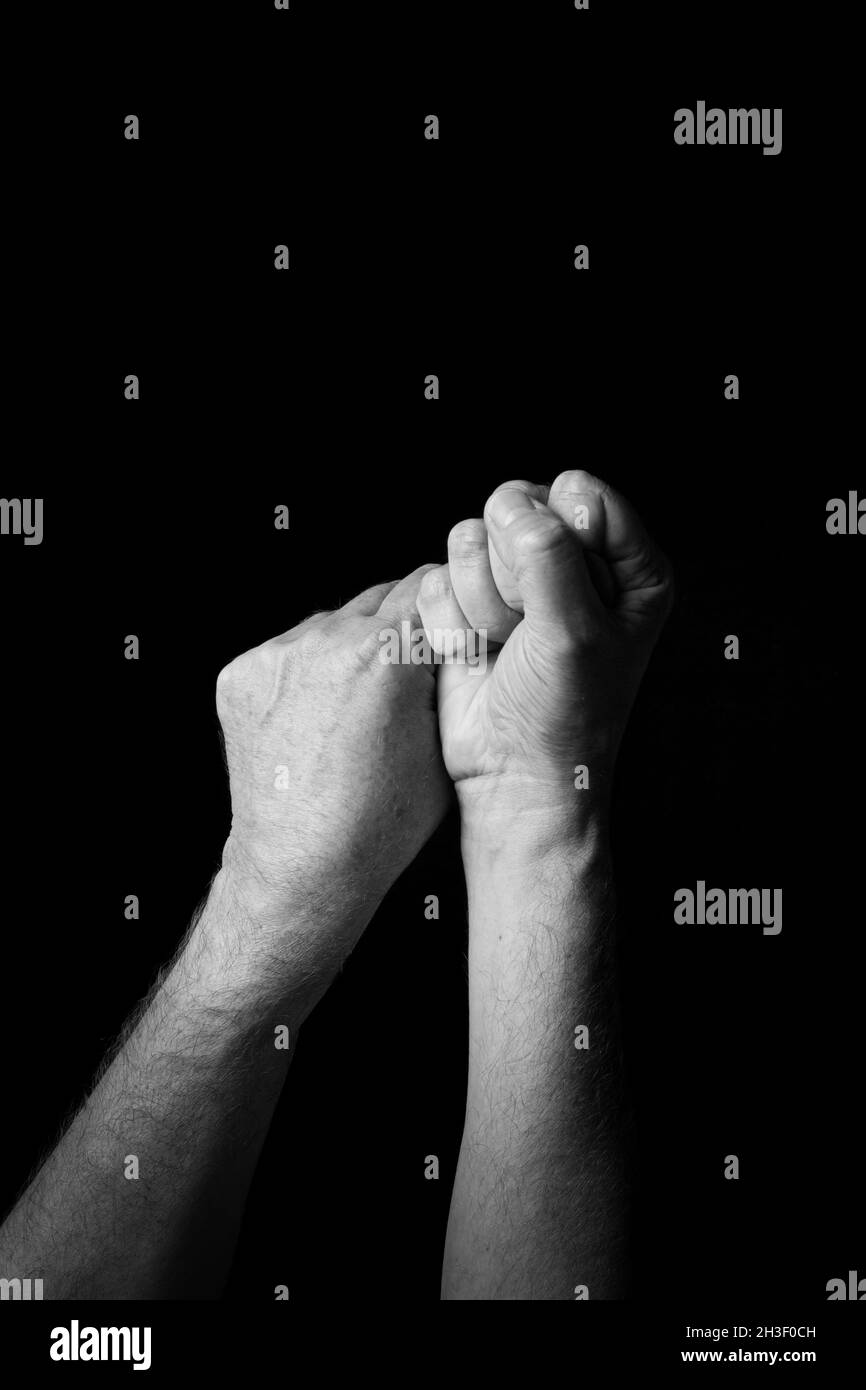 Dramatic B+W image of male hand fingerspelling BSL British sign ...