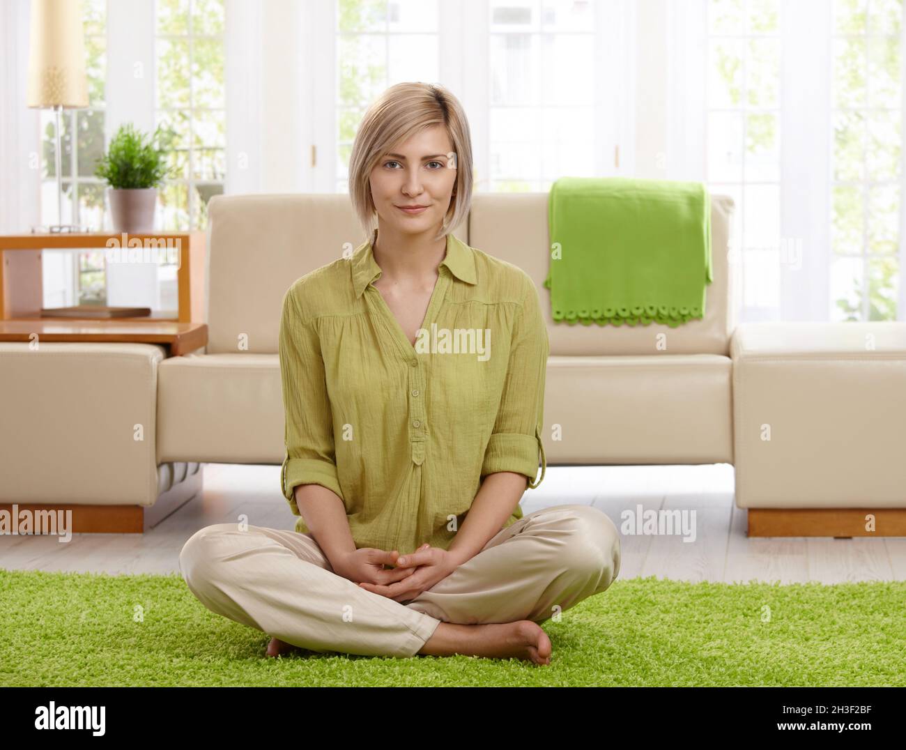 Woman on living room floor Stock Photo - Alamy
