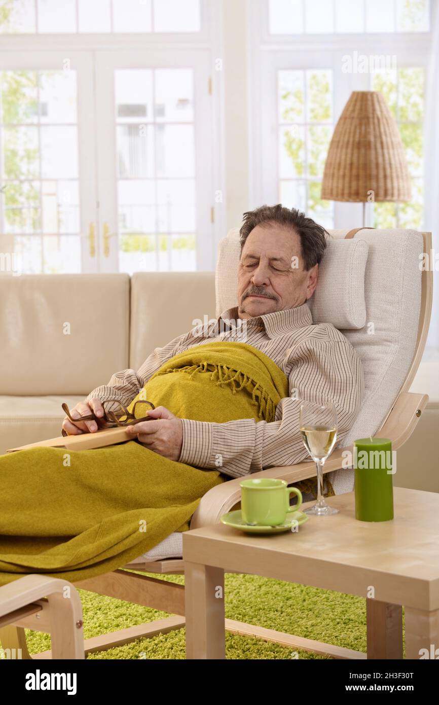Senior man sleeping in armchair Stock Photo - Alamy