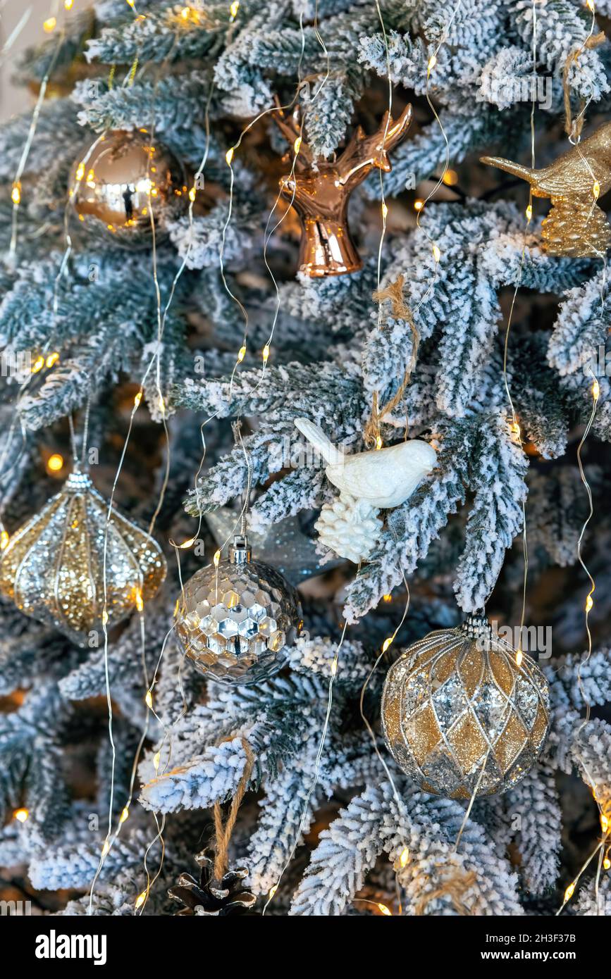 Christmas tree background. Seasonal background with Christmas ornaments on the tree. Festive Card. Celebration concept. Soft focus. Vertical photo Stock Photo