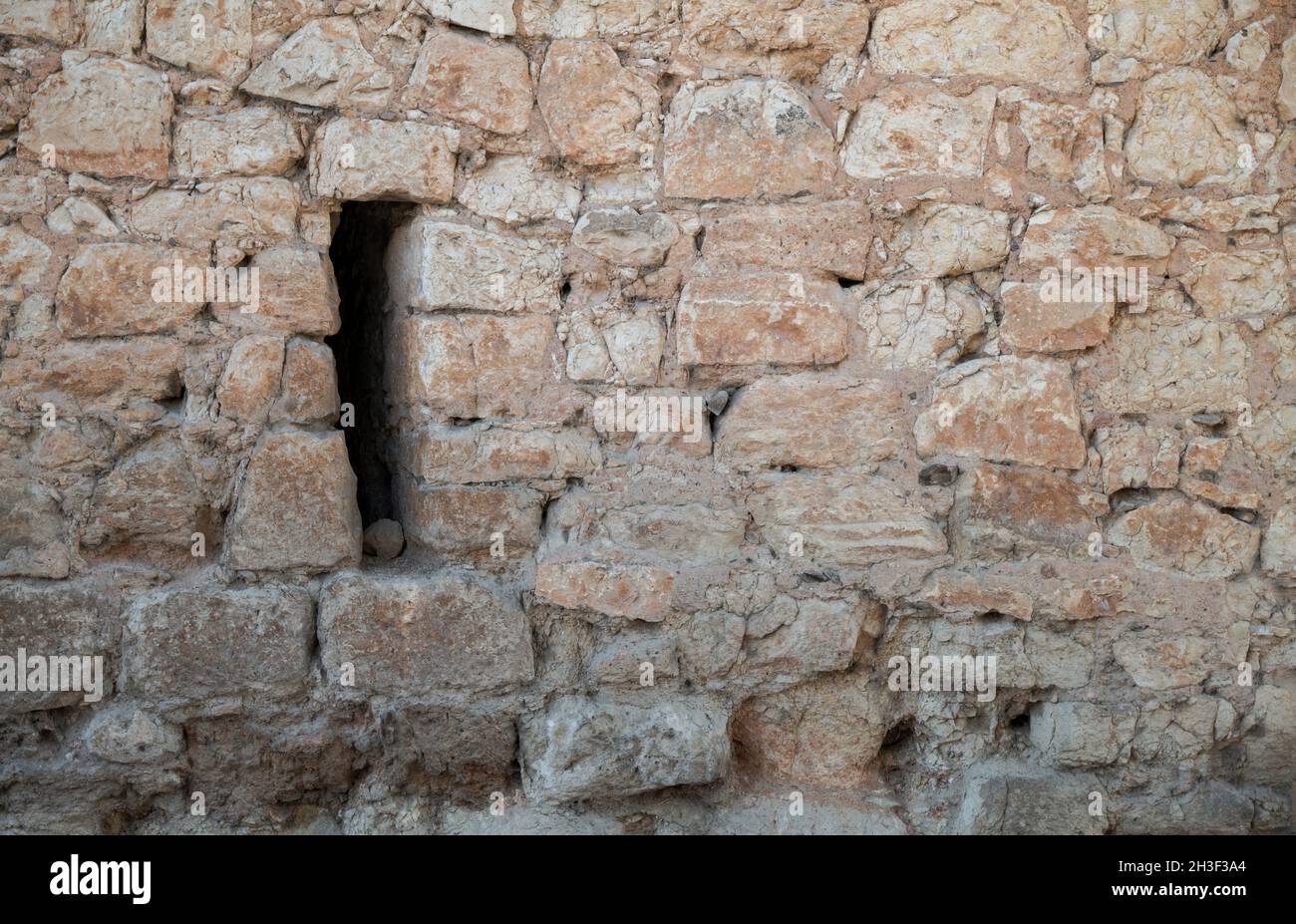 Small window on stone wall in Ayllon, Spain Stock Photo