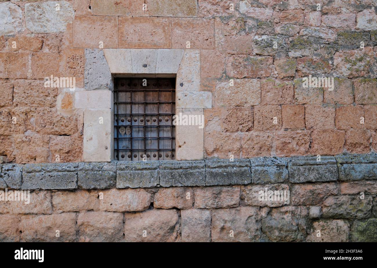 Small window on stone wall in Ayllon, Spain Stock Photo