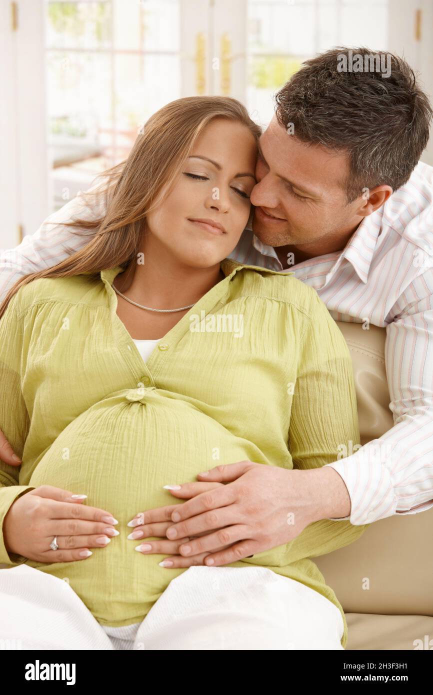 Man embracing pregnant woman Stock Photo - Alamy