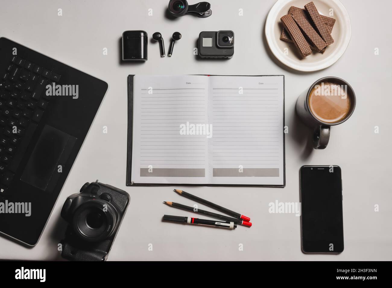 flat lay, books are in the middle with coffee and gadgets, to be productive Stock Photo