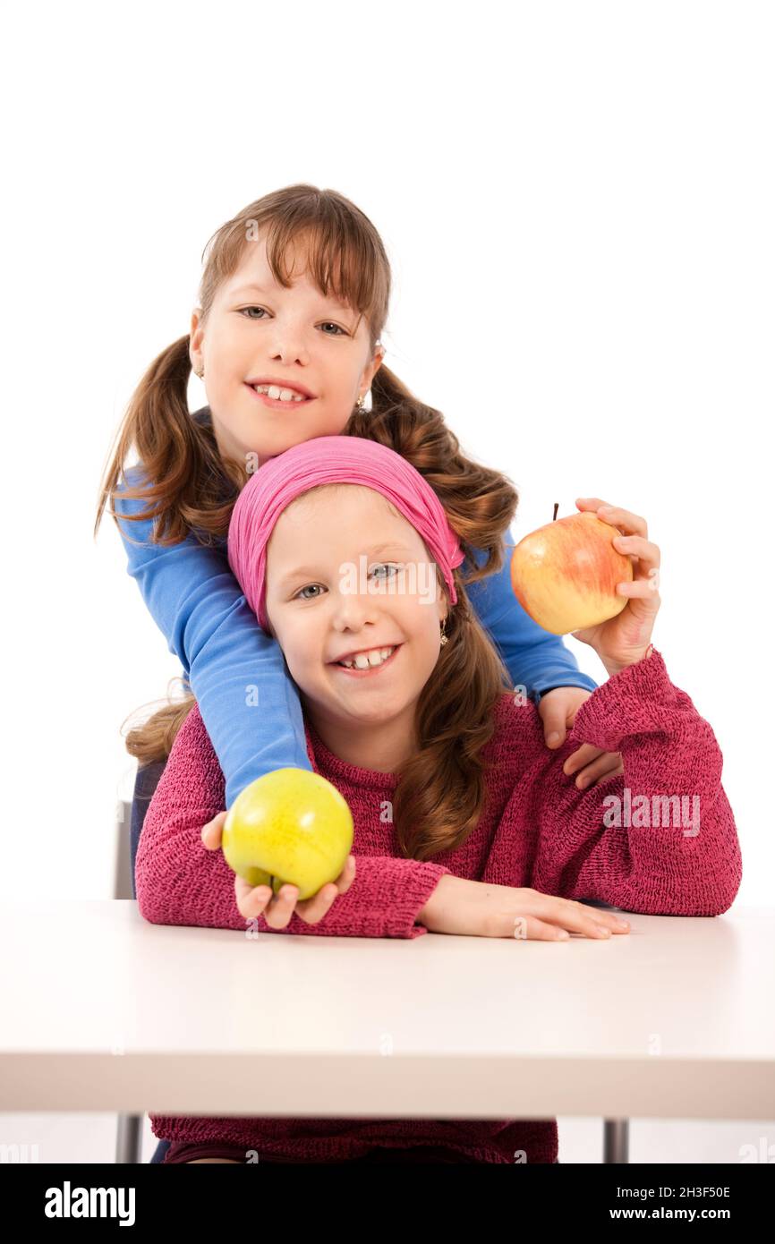 Schoolgirls with apples Stock Photo