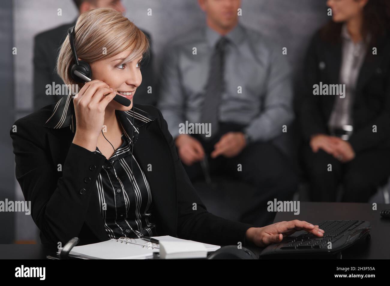 Businesswoman using headset Stock Photo