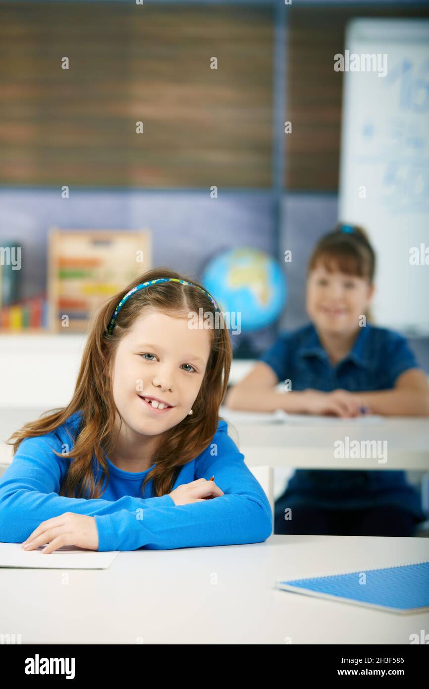 Happy schoolgirls in classroom Stock Photo - Alamy