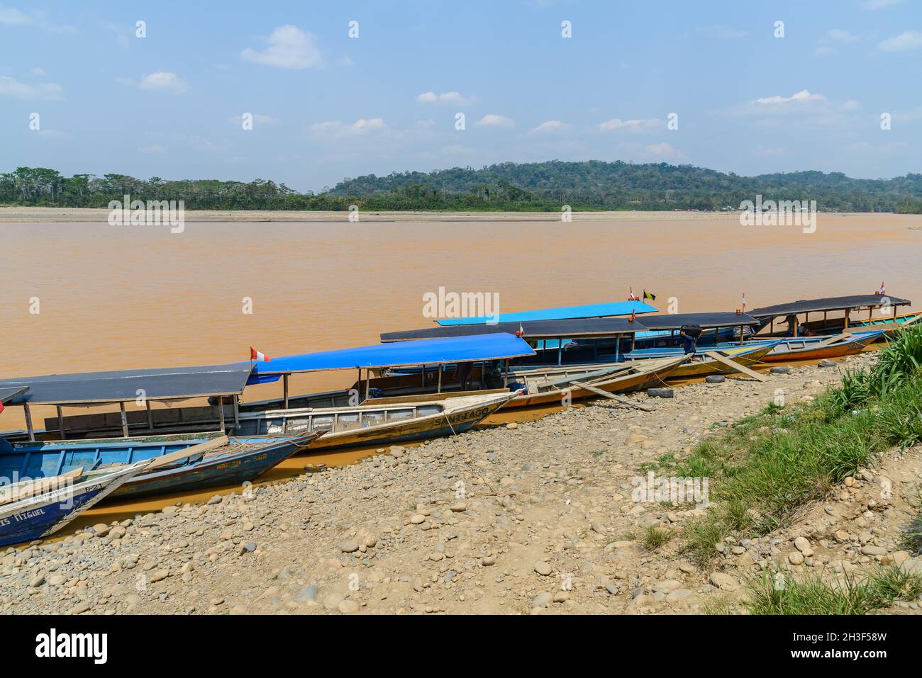 Small motor boat is the main transportation along Rio Madre de Dios in the Peruvian Amazon. Madre de Dios, Peru. Stock Photo