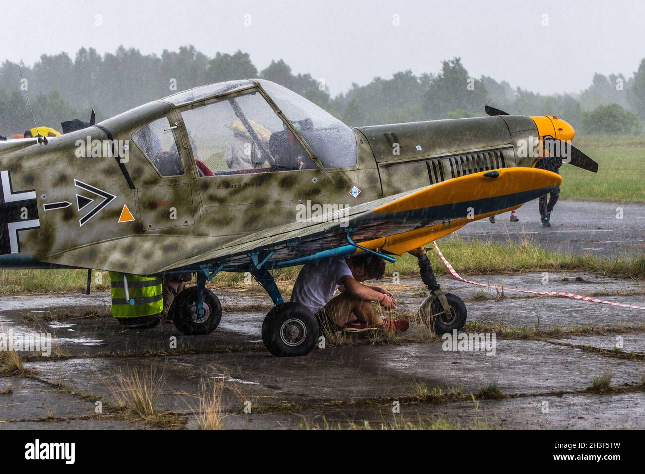 Biala Podlaska, Poland - June 22, 2014: Polish Aviation Legends (Fundacja Legendy Lotnictwa) open day - Zlin 42 (SP-AKF) in heavy rain Stock Photo