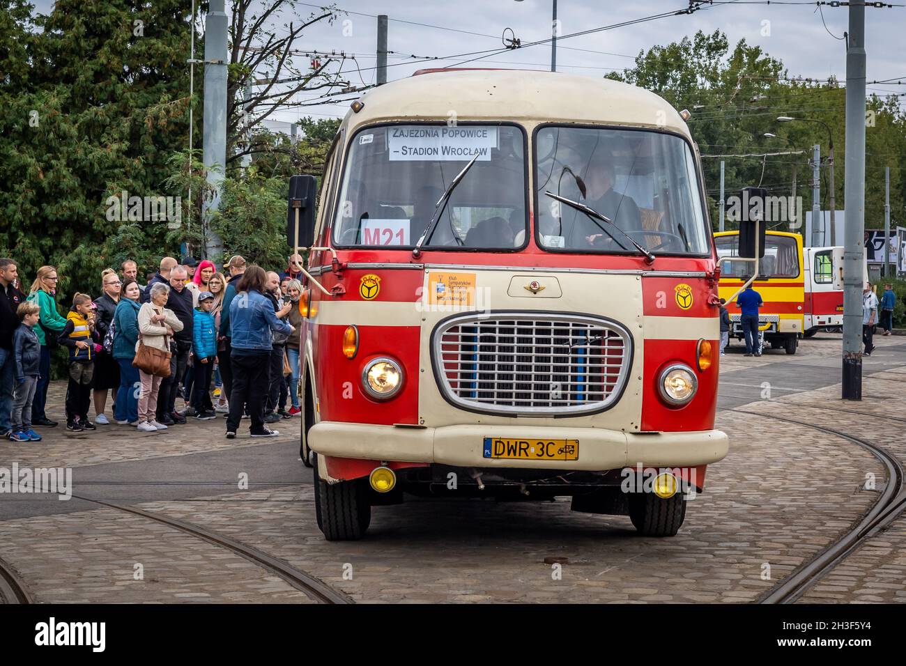 Wroclaw, Poland - September 19, 2021: A queue of passengers getting into a vintage red and cream Skoda bus at the bus station. Stock Photo