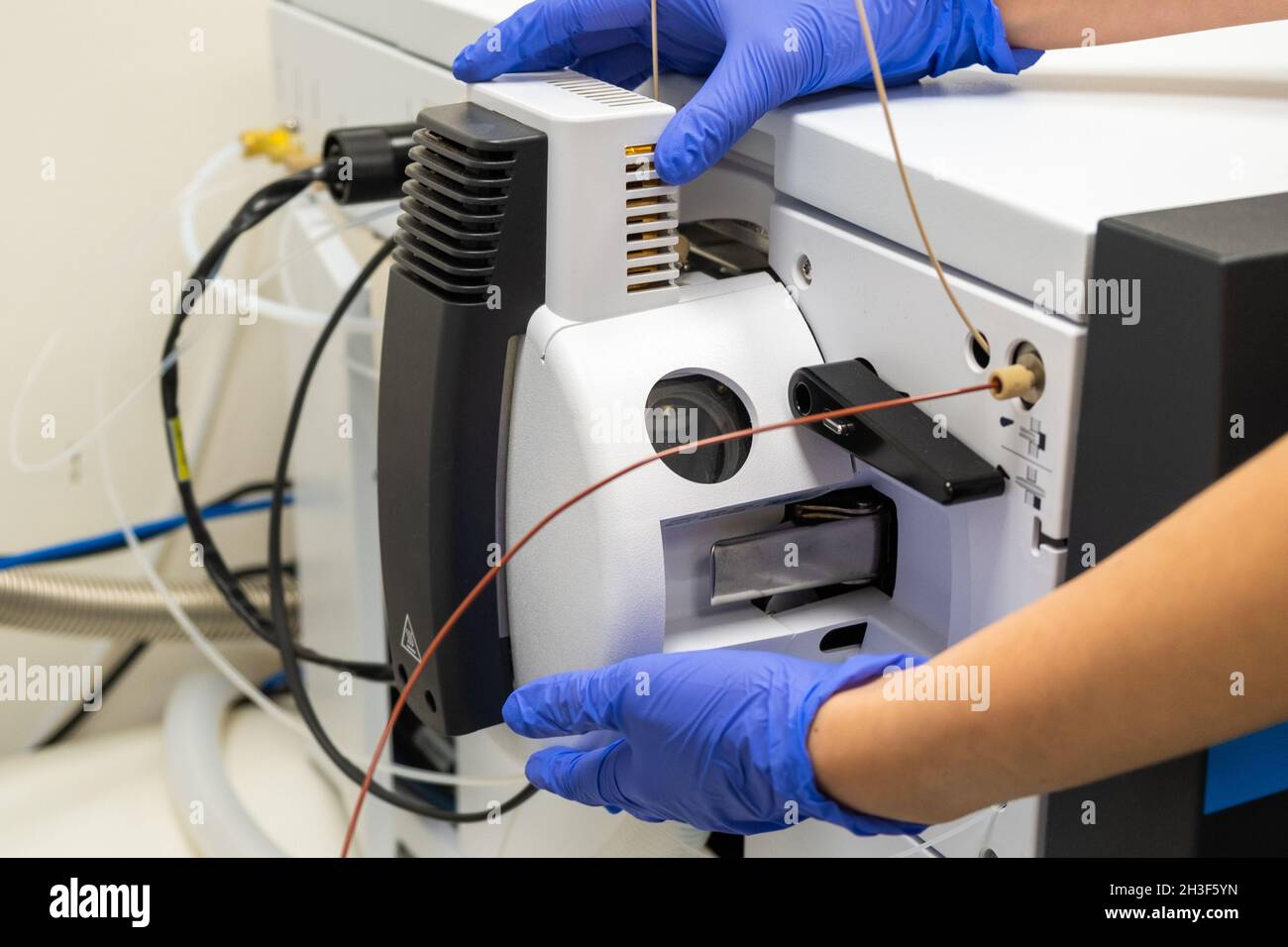 Chemist opening ion source of mass spectrometer for cleaning. Liquid