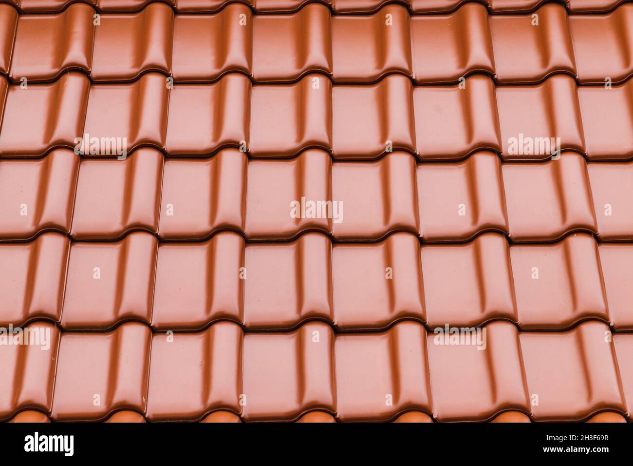 Shiny red new roof tiling, background photo texture Stock Photo