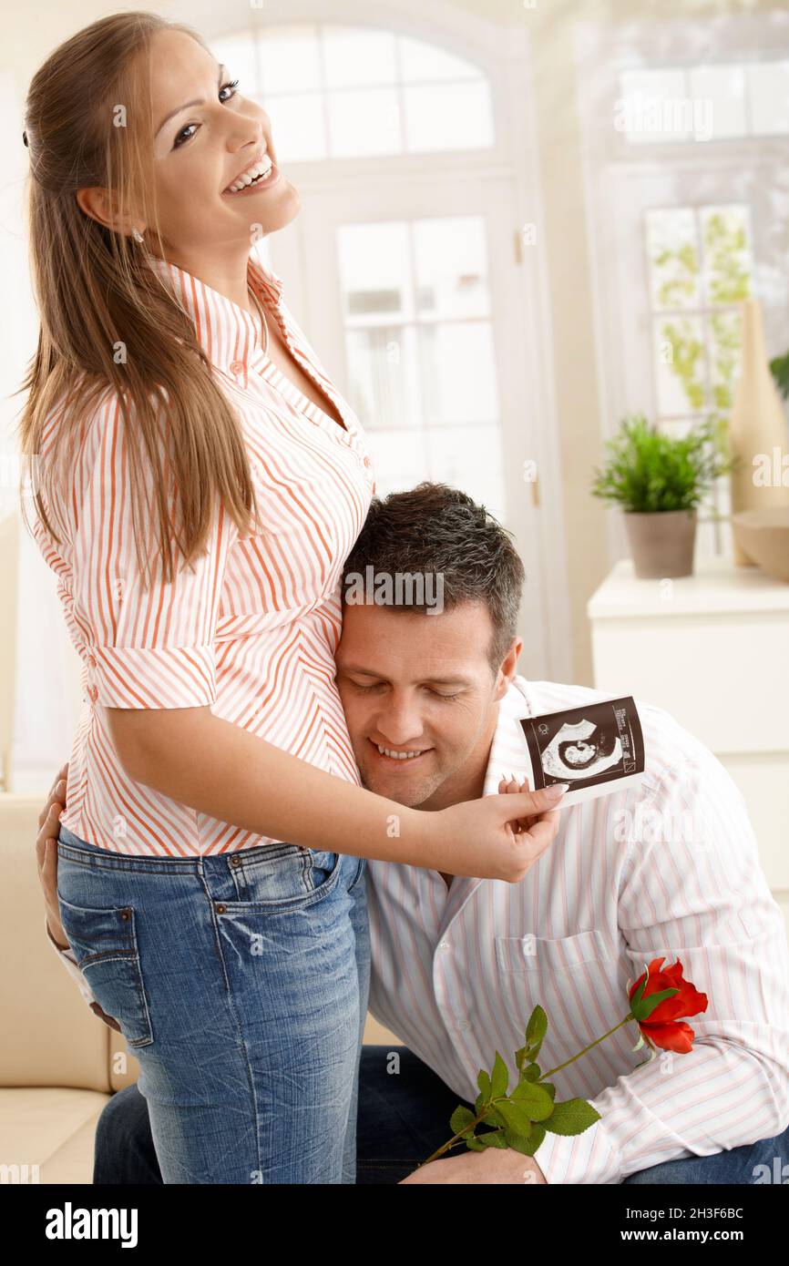 Man hugging pregnant woman Stock Photo - Alamy