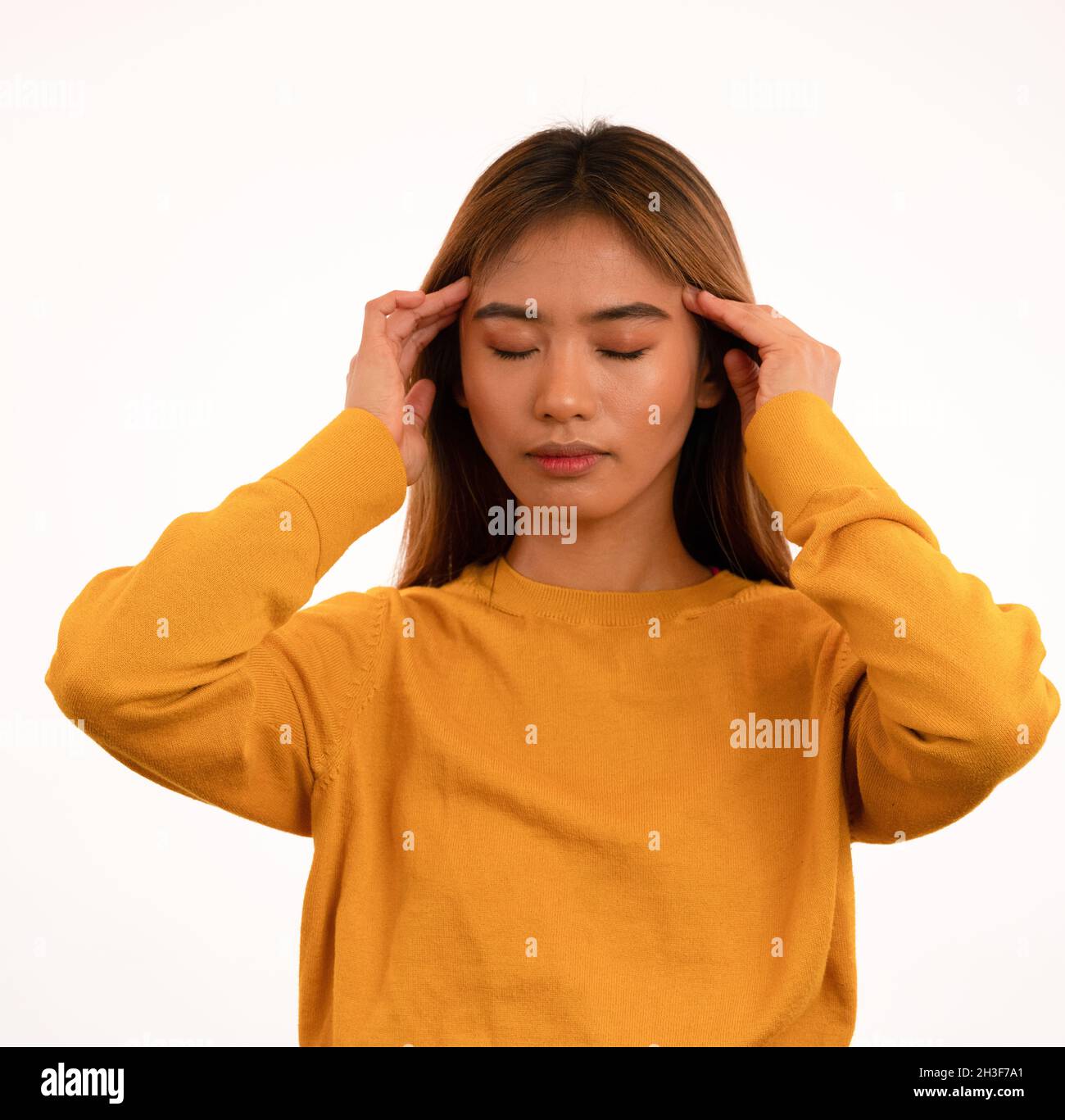 Young attractive asian girl thinking ideas in studio Stock Photo