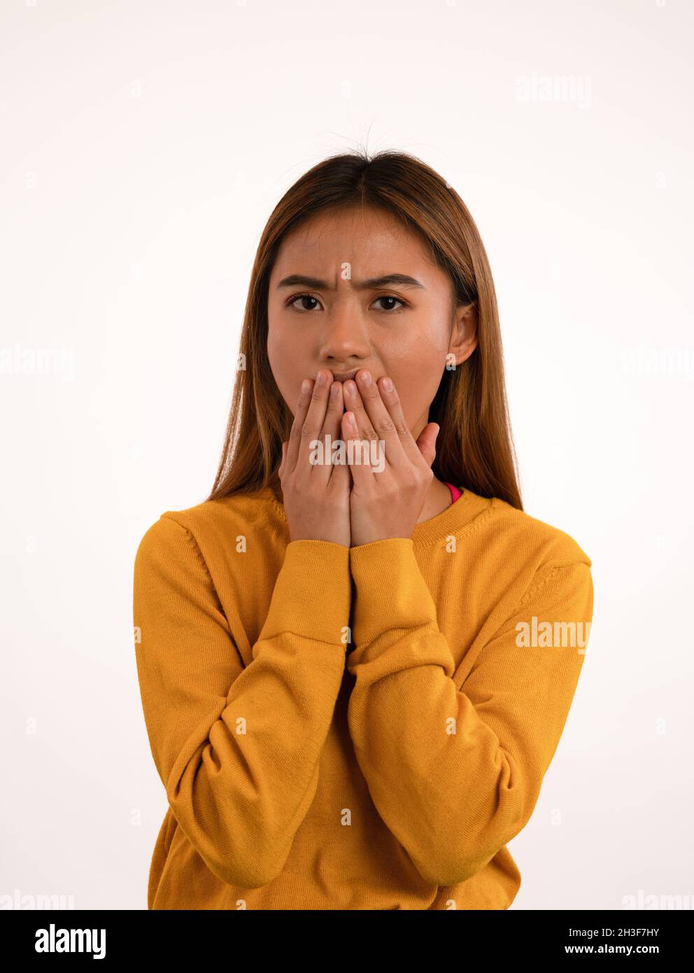 Young attractive shocked asian girl in studio Stock Photo