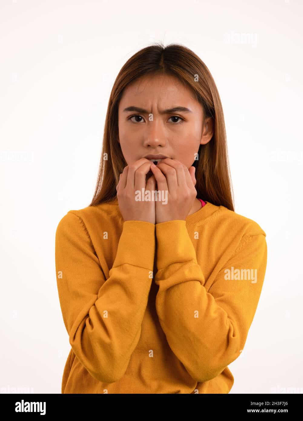 Young attractive nervous scared asian girl in studio Stock Photo