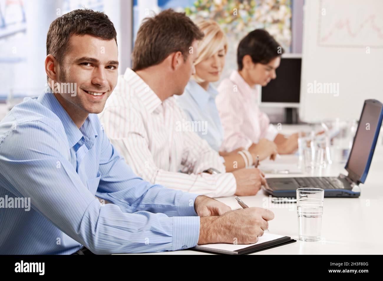 Businessman making notes on presentation Stock Photo