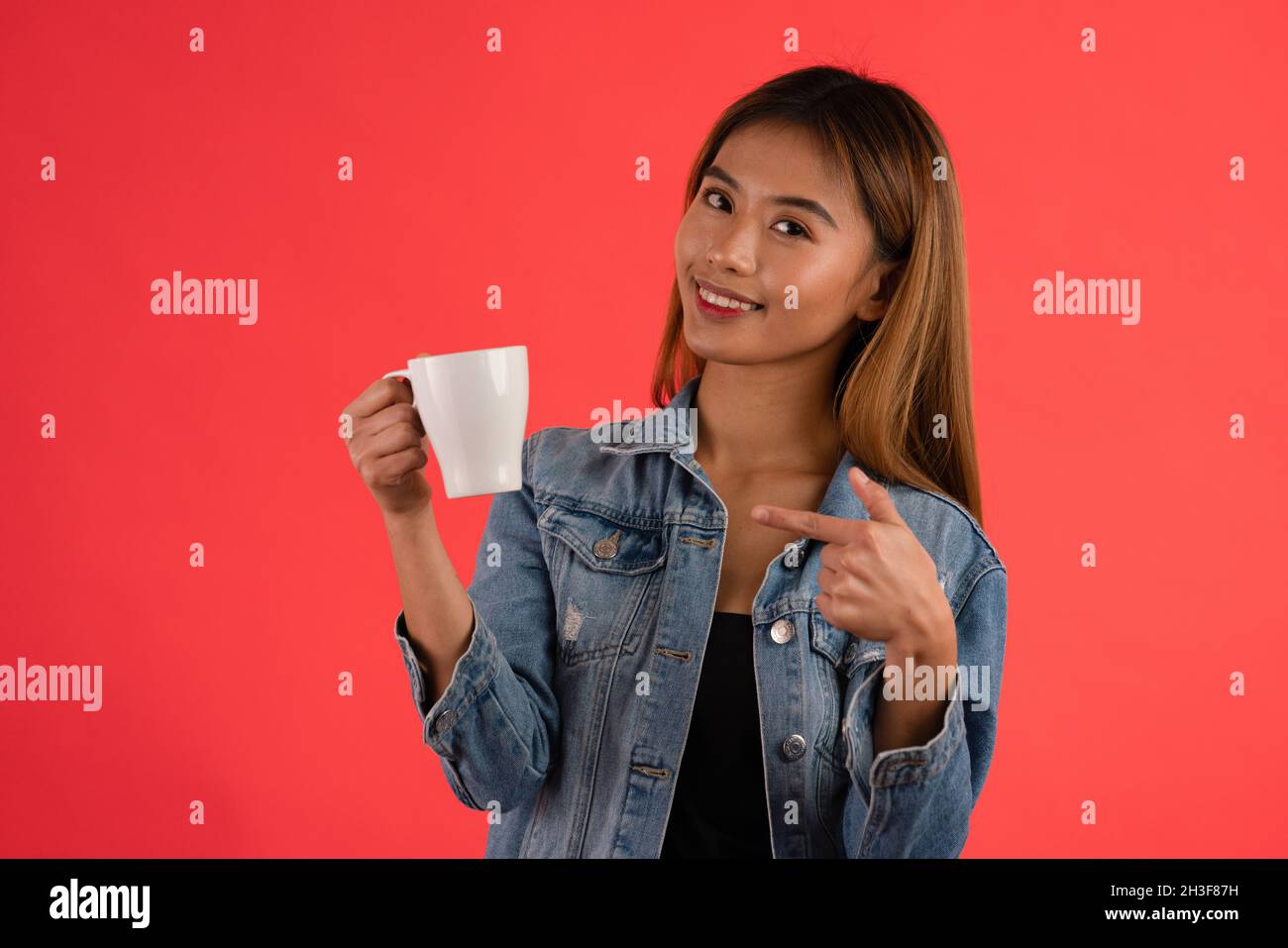 Young attractive asian coffee lover girl in studio Stock Photo