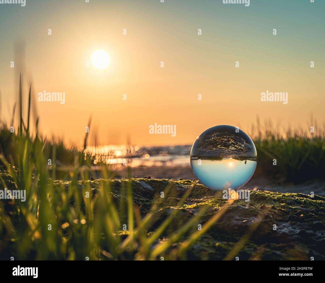 Beautiful sunset at north sea beach with a lensball Stock Photo - Alamy