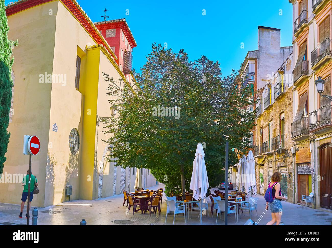 The outdoor cafe in shade of trees in the Encarnacion Square, next to the medieval Convent of Sisters of the Incarnation, Granada, Spain Stock Photo