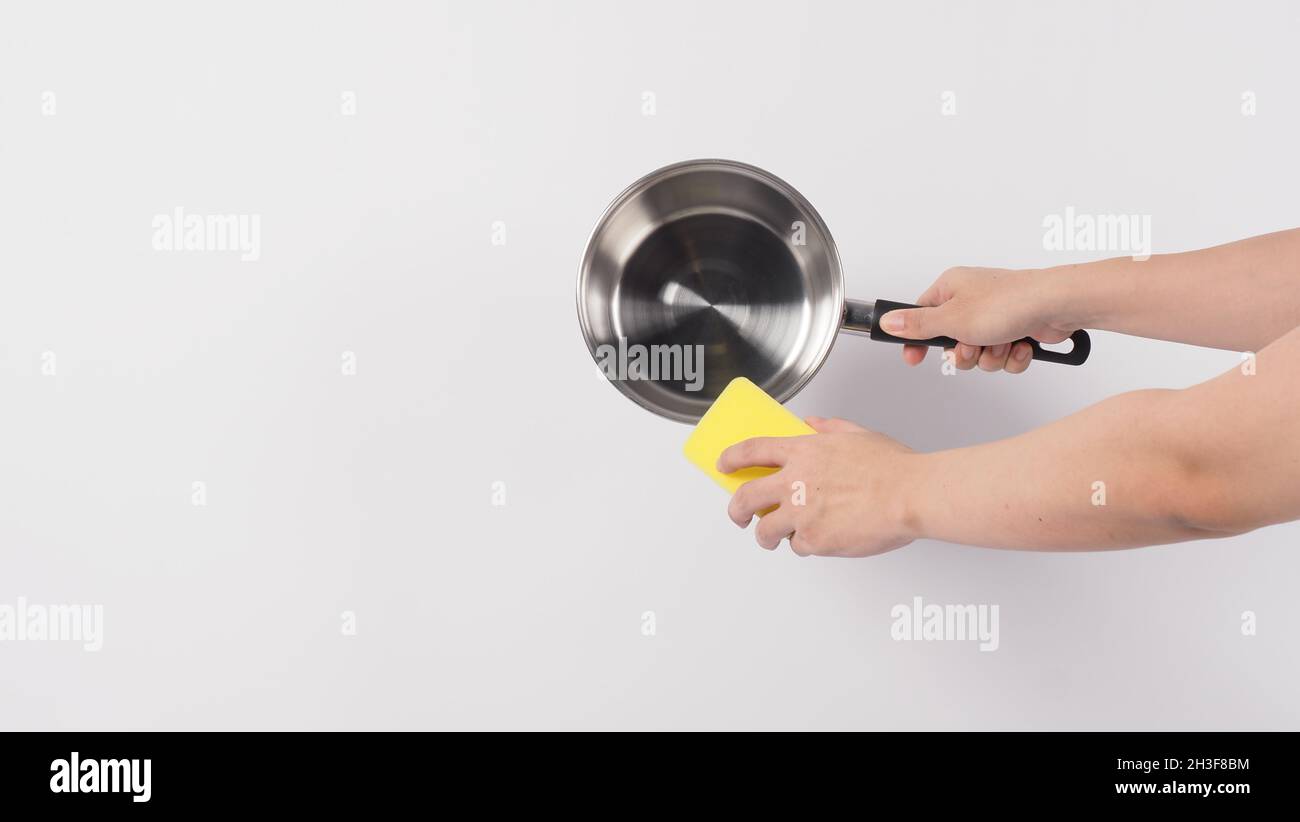 Hand cleaning the non stick pan with handy dish washing sponge 6122642  Stock Photo at Vecteezy