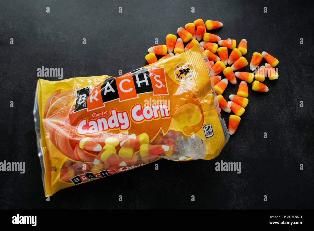 Moscow, Russia, September 2021: Candy corn Brachs spilled out of the pack. Halloween sweets. Copy space. Stock Photo